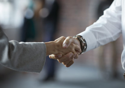 Businesspeople making handshake at conference