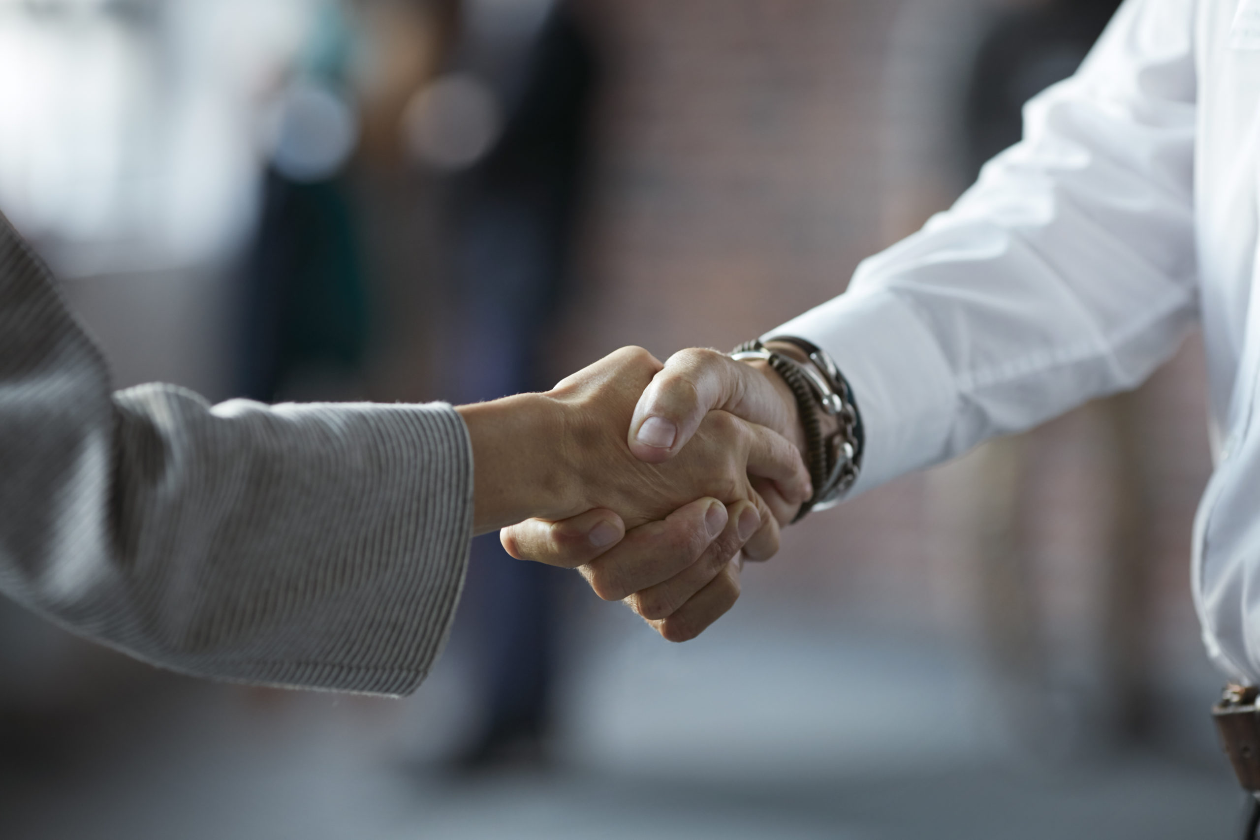 Businesspeople making handshake at conference